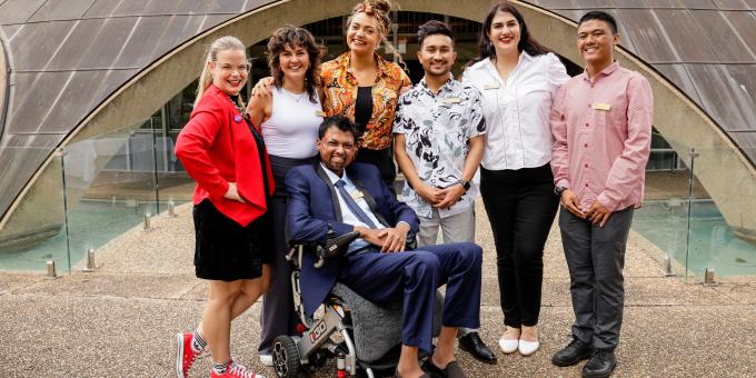 Image of seven young people standing together smiling representing the Young Australian of the Year Category Lunch - Australian of the Year Awards 2024.