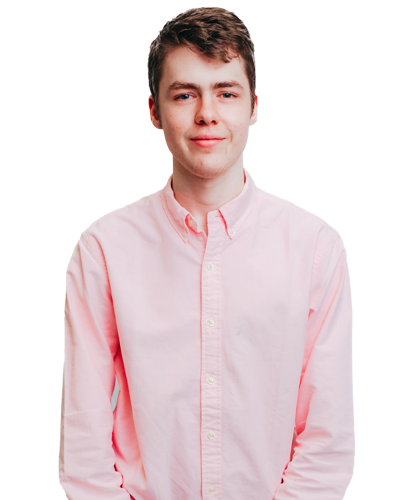 Head shot of Seb. Young person with short brown hair wearing a salmon coloured, collared shirt.