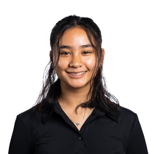 Headshot of Alya smiling at the camera with shoulder length straight hair.