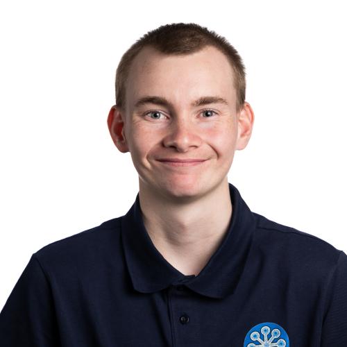 Image of Aston smiling with very short hair wearing a collared shirt.