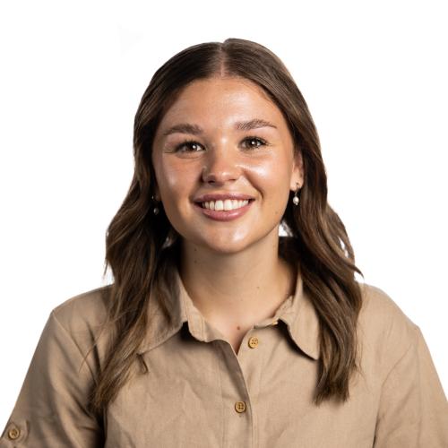 Image of Bianca smiling with shoulder length hair and a collared shirt.