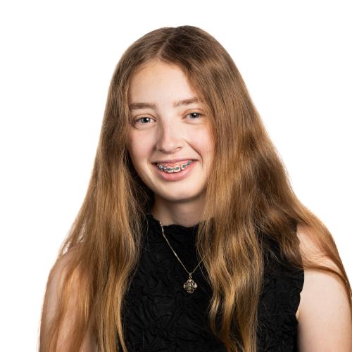 Image of Isabella smiling with long straight hair wearing a sleeveless top.