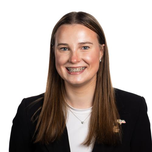 Image of Jazmin smiling with long straight hair, wearing a t-shirt and a blazer.