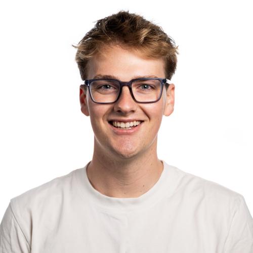Image of Kane with short hair, wearing glasses and a t-shirt.