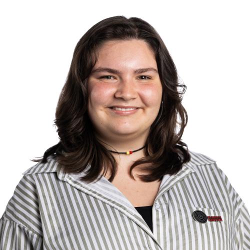 Image of Matilda smiling with shoulder length hair wearing a collared shirt.