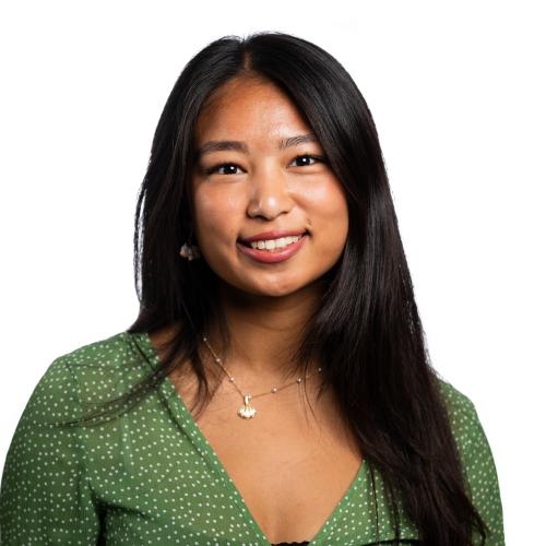Image of a female named Nairwng smiling at the camera with long, straight hair.