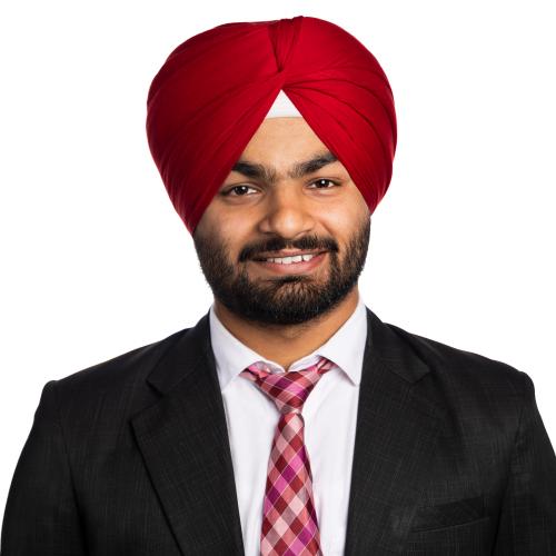 Image of Sunny smiling wearing a turban, collared shirt, tie and blazer.