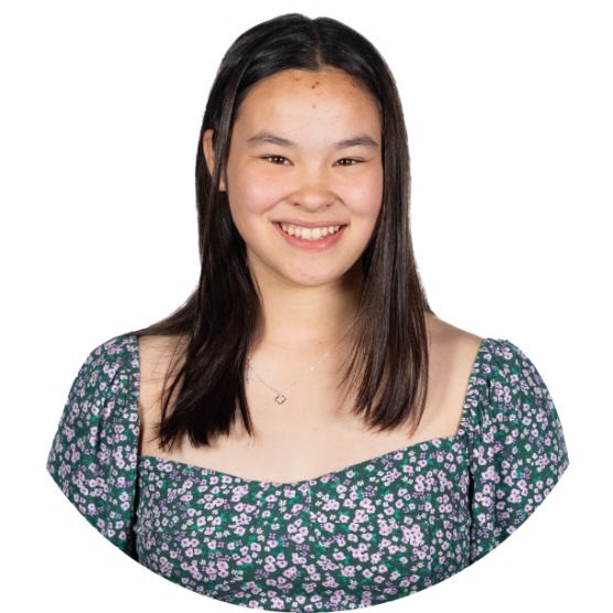 A young person wearing a floral blouse with long, dark straight hair smiling.