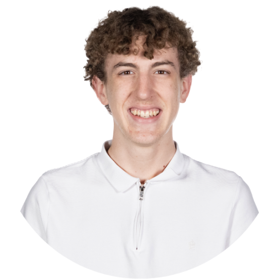 Young person wearing a white collared shirt, with short brown hair, smiling.