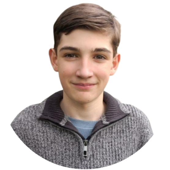 Young person wearing a grey woollen jumper, smiling.
